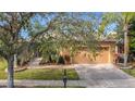 House exterior with a driveway and landscaping at 512 Heartwell Dr, Poinciana, FL 34759
