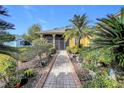 Brick walkway to the front door with lush landscaping at 512 Heartwell Dr, Poinciana, FL 34759