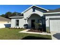 House exterior with two-car garage and landscaping at 932 Albertville Ct, Kissimmee, FL 34759