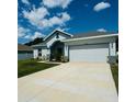 Two-car garage and well-maintained front yard at 932 Albertville Ct, Kissimmee, FL 34759