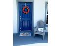 Inviting front entrance with a blue door and decor at 932 Albertville Ct, Kissimmee, FL 34759