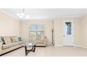 Bright living room with neutral walls, tile floors, and an inviting view of the outdoors at 9475 Randal Park Blvd, Orlando, FL 32832