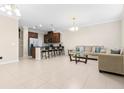 Bright, open living room with tile floors, seamlessly blending with kitchen and bar seating at 9475 Randal Park Blvd, Orlando, FL 32832