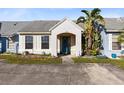 Front view of a light blue house with a teal door, landscaping, and driveway at 116 Candlewick Ct, Sanford, FL 32771