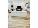 Open concept living area with hardwood floors and modern furniture at 11926 Sunsail Ave, Orlando, FL 32832