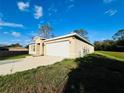 Single story house with a two-car garage and driveway at 1421 Swift Ct, Poinciana, FL 34759