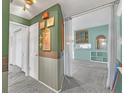 Bright hallway with green walls and access to other rooms at 1607 W Oak St, Kissimmee, FL 34741