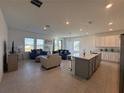 Open living room and kitchen area with tile flooring and comfy furniture at 1625 Hill Park Dr, Deltona, FL 32725