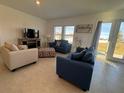 Bright living room with tile floors, two sofas, and access to backyard at 1625 Hill Park Dr, Deltona, FL 32725