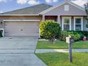 One story home with a two car garage and mailbox at 1850 Patriot Way, Saint Cloud, FL 34769