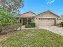 House with a two-car garage and manicured lawn at 243 New River Dr, Kissimmee, FL 34759