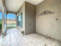 Covered porch with tile floor and green shutters at 243 New River Dr, Kissimmee, FL 34759