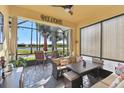 Enclosed patio with seating area overlooking a golf course at 2448 Palm Tree Dr, Kissimmee, FL 34759