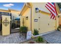 House exterior with paver driveway and American flag at 2448 Palm Tree Dr, Kissimmee, FL 34759