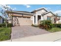 Tan house with a two-car garage and attractive landscaping at 2756 Greenlands St, Saint Cloud, FL 34772