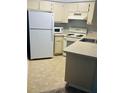 Small kitchen with white appliances and light countertops at 3854 Southpointe Dr # 1, Orlando, FL 32822