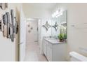 Modern bathroom with granite countertop, double vanity, and stylish decor at 4154 Lana Ave, Davenport, FL 33897