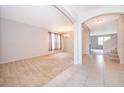 Open floor plan dining room with neutral carpeting and tile flooring at 437 Seattle Slew Dr, Davenport, FL 33837