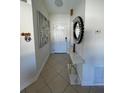Bright entryway with tiled floors and a modern console table at 511 Kilimanjaro Dr, Kissimmee, FL 34758