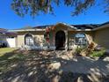 Front view of a single story house with a landscaped yard at 511 Kilimanjaro Dr, Kissimmee, FL 34758