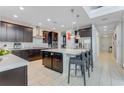 Spacious kitchen featuring a large island and dark cabinetry at 7211 Still Pond Ln, Windermere, FL 34786