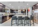 Modern kitchen with island, stainless steel appliances, and dark cabinetry at 7211 Still Pond Ln, Windermere, FL 34786