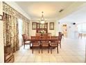 Formal dining room featuring a tile floor, traditional furniture, and elegant decor at 8557 La Isla Dr, Kissimmee, FL 34747