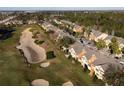 Community of townhouses near a golf course with sand traps at 904 Assembly Ct, Reunion, FL 34747
