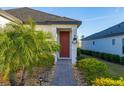 Inviting front door entry with brick walkway and lush landscaping at 939 Braewood Dr, Clermont, FL 34715