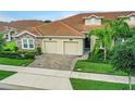 Two-story home with tile roof and a paved driveway at 1066 Quaker Ridge Ln, Davenport, FL 33896