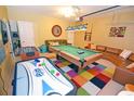 Finished basement with a pool table, air hockey, and seating at 160 Hideaway Beach Ln, Kissimmee, FL 34746