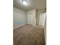Spacious bedroom with neutral carpeting and double door closet at 1655 Aspen Ave, Davenport, FL 33837