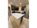 Kitchen island with white quartz countertop and ample storage space at 1655 Aspen Ave, Davenport, FL 33837