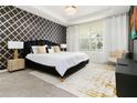 Spacious main bedroom with a black velvet headboard, gold accents, and large windows at 1829 Tropical Palms Cir Cir, Kissimmee, FL 34747