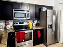 Modern kitchen with stainless steel appliances and granite countertops at 1855 Caralee Blvd # 2, Orlando, FL 32822