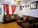 Living room with brown couches and wood flooring at 1855 Caralee Blvd # 2, Orlando, FL 32822