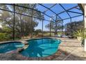 Relaxing pool and spa with screened enclosure and golf course view at 1867 Flora Pass Pl, Kissimmee, FL 34747