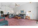 Living room with couches, coffee table, and pink carpeting at 201 Steamboat Blvd, Davenport, FL 33897