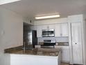 Modern kitchen featuring stainless steel appliances and granite countertops at 2218 Grand Cayman Ct # 1335, Kissimmee, FL 34741