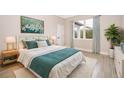 Bright bedroom with a queen-size bed and large window at 2827 Sw 137Th Ln, Ocala, FL 34473