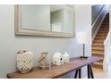 Entryway with console table, mirror, and stairs at 2950 Buccaneer Palm Rd, Kissimmee, FL 34747