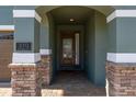 Front entry with a stone archway and a dark brown door at 370 Burma St, Kissimmee, FL 34747