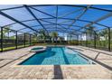 Inviting screened-in pool and spa with a spacious patio area at 370 Burma St, Kissimmee, FL 34747