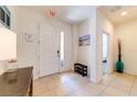 Bright and airy entryway with tile flooring and a bench at 4723 Terrasonesta Dr, Davenport, FL 33837