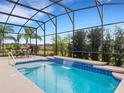 Inviting pool area with a water feature and screened enclosure at 580 Cantabria Dr, Davenport, FL 33837