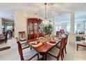 Formal dining room with a large wooden table and chandelier at 605 Pinehurst Ct, Kissimmee, FL 34758