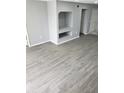 Bright living room featuring gray vinyl flooring and built-in shelving at 13803 Fairway Island Dr # S, Orlando, FL 32837