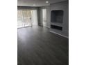 Living room with gray vinyl flooring, sliding doors, and a built-in shelf at 13803 Fairway Island Dr # S, Orlando, FL 32837