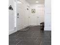 Bright entryway with dark tile floors and white doors at 152 Pinewood Dr, Davenport, FL 33896