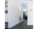 Clean hallway with dark tile floors and staircase to upper level at 152 Pinewood Dr, Davenport, FL 33896
